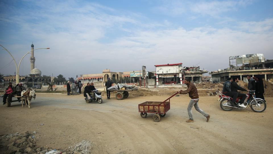 An Iraqi man pushes a cart in Mosul after the government retook control from the Islamic State in 2017. <a href="https://media.gettyimages.com/id/632292674/photo/topshot-iraq-conflict-mosul.jpg?s=1024x1024&w=gi&k=20&c=Nhx4QWu-dMm2zA-P6RdP4cf62WwjFwQMUkSrHcfjkf4=" rel="nofollow noopener" target="_blank" data-ylk="slk:Ahmad Al-Rubaye/AFP via Getty Images;elm:context_link;itc:0;sec:content-canvas" class="link ">Ahmad Al-Rubaye/AFP via Getty Images</a>