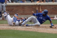 Toronto Blue Jays' Marcus Semien scores a run in front of New York Mets catcher Tomas Nido in the sixth inning during a baseball game Sunday, July 25, 2021, in New York. (AP Photo/Adam Hunger)