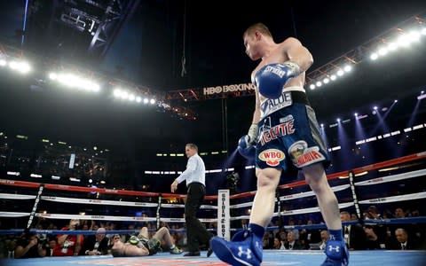 Canelo Alvarez, right, looks toward Liam Smith after knocking him down in 2016 - Credit: Getty Images 