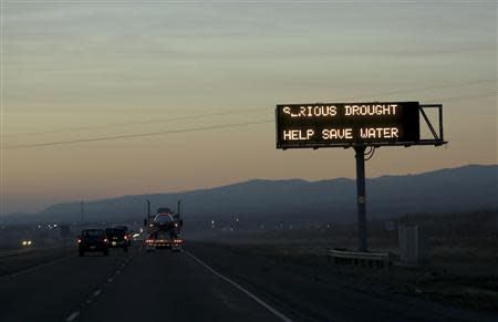 A sign advising motorists of a drought is seen along Interstate 5 near Canuta Creek, California in this February 14, 2014 file photo. REUTERS/Robert Galbraith/Files