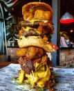 Is this Australia's biggest burger? 4 Beef Patties, 2 Pieces of Southern Fried Chicken, 6 Layers of Bacon, 6 Layers of Cheese, 6 Mac 'n' Cheese Nuggets, Double Lettuce, Tomato & Onion, Tonnes of Bacon Relish, Social Mayo & Ketchup. All between 3 lightly toasted buttermilk buns. Photo: Supplied/@southsidesocial