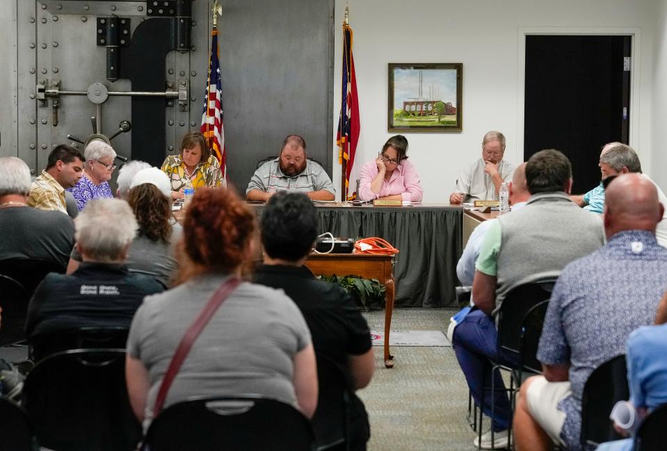 East Palestine Mayor Trent Conaway, center, leads a city council meeting Monday, July 24, 2023, as the city continues to recover after a train derailment in February that caused an evacuation of residents. At the time of the derailment, Conaway worked part-time as mayor while working a full-time job. He recently quit the full-time job to be more dedicated to the village of 4,700 residents.