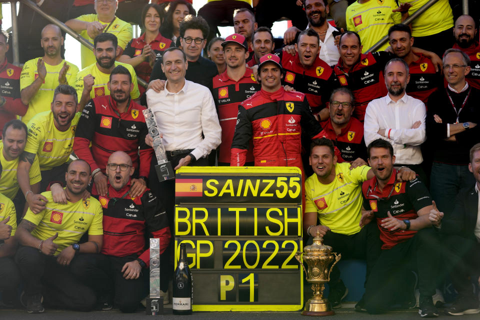 Ferrari driver Carlos Sainz, center right, of Spain poses with his team as he celebrates after winning the British Formula One Grand Prix at the Silverstone circuit, in Silverstone, England, Sunday, July 3, 2022. (AP Photo/Frank Augstein)