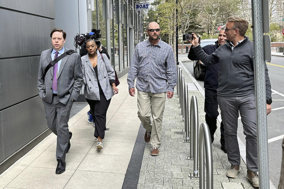 A member of Jack Teixeira's family, center, leaves the Moakley Federal Courthouse, Wednesday, April 19, 2023, in Boston. Teixeira, the Massachusetts Air National Guardsman charged with leaking highly classified military documents, made a brief court appearance Wednesday, as a hearing to determine whether he should remain jailed while awaiting trial was delayed to give the defense more time to prepare. (AP Photo/Michael Casey)