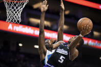 Sacramento Kings guard De'Aaron Fox (5) shoots as Orlando Magic center Mo Bamba defends during the first quarter of an NBA basketball game in Sacramento, Calif., Wednesday, Dec. 8, 2021. (AP Photo/Jose Luis villegas)