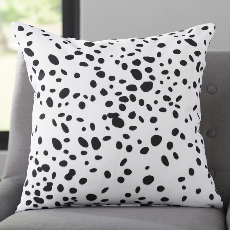 the black spotted pillow on a couch