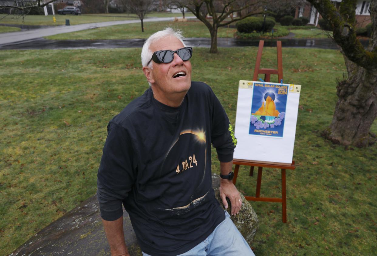 Wearing a pair of solar eclipse glasses, Patrick Moriarty looks skyward from his yard in Rochester Friday, March 15, 2024.