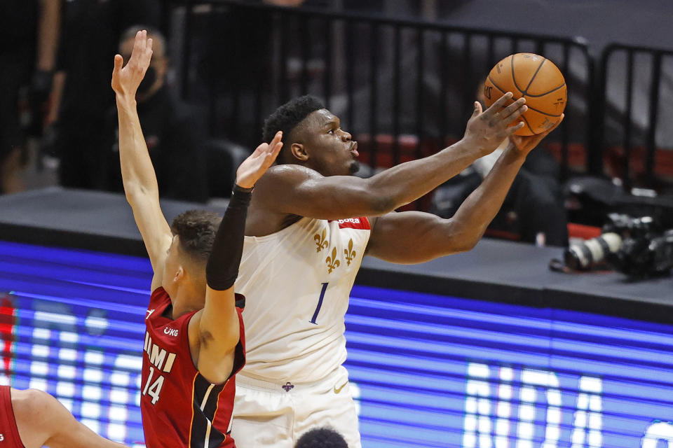 New Orleans Pelicans forward Zion Williamson (1) goest the basket past Miami Heat guard Tyler Herro (14) during the second half of an NBA basketball game, Friday, Dec. 25, 2020, in Miami. (AP Photo/Joel Auerbach)