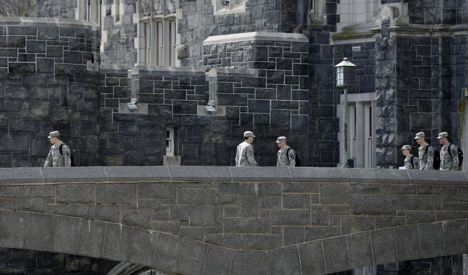 In this April 9, 2014 photo, West Point cadets walk on campus during lunchtime break at the United States Military Academy in West Point, N.Y. With the Pentagon lifting restrictions for women in combat jobs, Lt. Gen. Robert Caslen Jr. has set a goal of boosting the number of women above 20 percent for the new class reporting this summer. (AP Photo/Mel Evans)