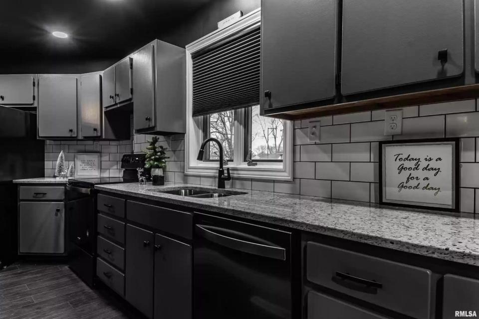 The kitchen has additional spotlights to provide brightness in the dark home.