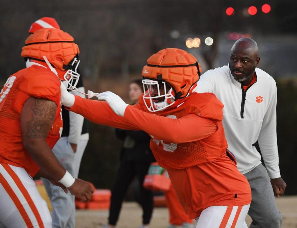 The Clemson Football Tigers prepare to face the Kentucky Wildcats in the 2023 Gator Bowl. The team held practice on Dec. 14, 2023 to prepare for the game. Clemson coach Chris Rumph, right, on the field.