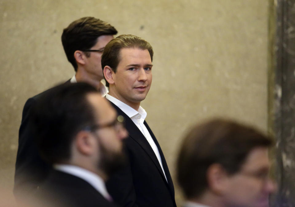 Former Austrian Chancellor Sebastian Kurz, center, appears at court on the first day of his trial in Vienna, Austria, Wednesday, Oct. 18, 2023. Kurz is charged with having allegedly making false statements to a parliamentary inquiry into alleged corruption in his first government. (AP Photo/Heinz-Peter Bader)