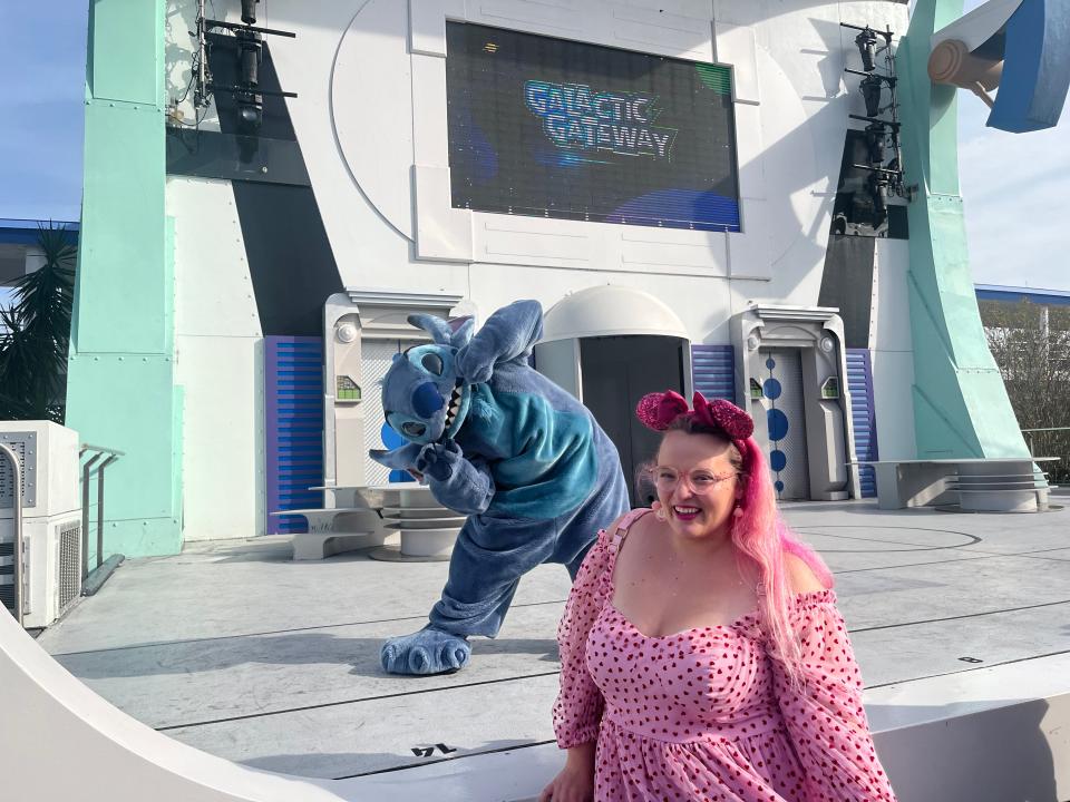 Casey Clark in front of stitch at magic kingdom