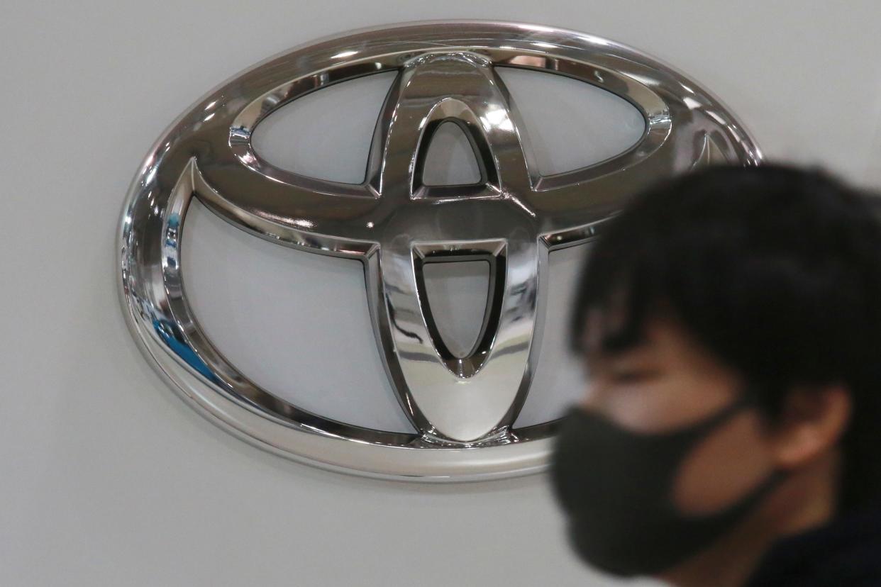 In this Nov. 2, 2020, file photo, visitor wearing walks by the logo of Toyota Motor Corp. (AP Photo/Koji Sasahara, File)
(Credit: The Associated Press)