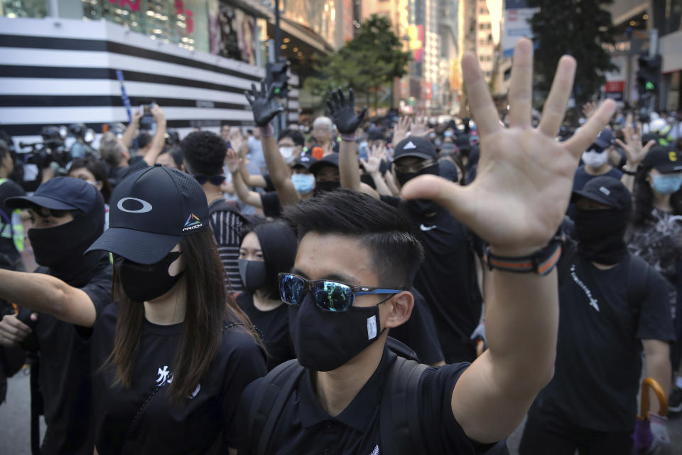 Demonstrators wearing masks gather during an anti-government protest in Hong Kong, Saturday, Nov. 2, 2019. Defying a police ban, thousands of black-clad masked protesters are streaming into Hong Kong's central shopping district for another rally demanding autonomy in the Chinese territory as Beijing indicated it could tighten its grip. (AP Photo/Kin Cheung)