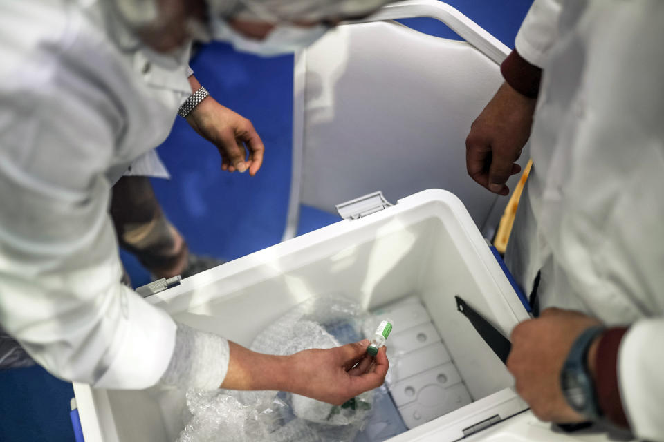 FILE - In this Jan. 29, 2021, file photo, health worker prepares doses of the AstraZeneca-Oxford COVID-19 vaccine on the first day of vaccination campaign, in Rabat, Morocco. As the coronavirus pandemic exploded worldwide last April, global organizations banded together to help ensure vaccines would be distributed fairly. But the COVAX initiative has been dogged by shortages of cash and supplies as well as logistical hurdles. Some poorer countries have been unwilling to wait for COVAX, and have found other ways to get vaccines. (AP Photo/Mosa'ab Elshamy, File)