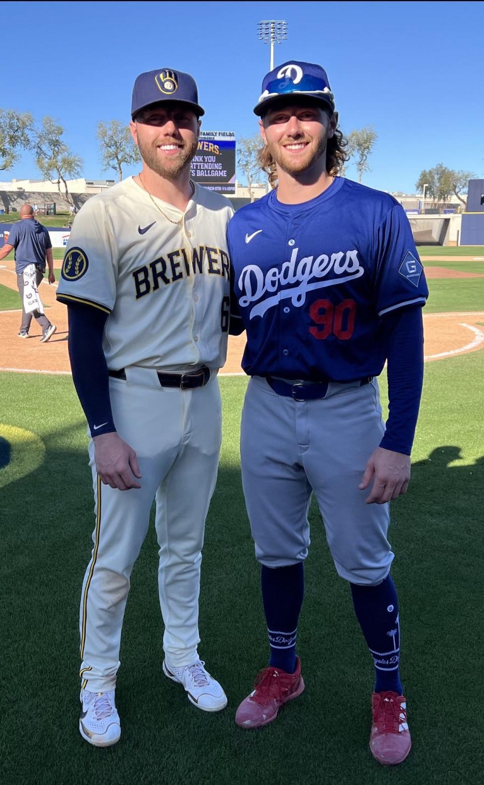 Brothers Owen Miller of the Brewers, and Noah Miller of the Dodgers, pose for a photo during Milwaukee's 11-3 loss to Los Angeles in a spring training game at American Family Fields in Phoenix on Saturday.