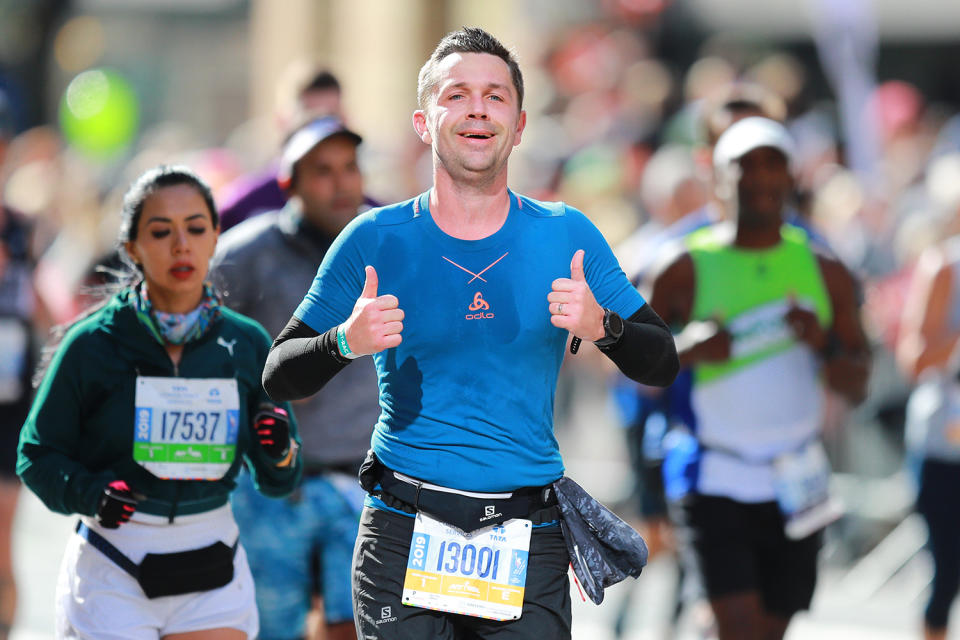 A participant gives two thumbs up while running in the 2019 New York City Marathon. (Photo: Gordon Donovan/Yahoo News)