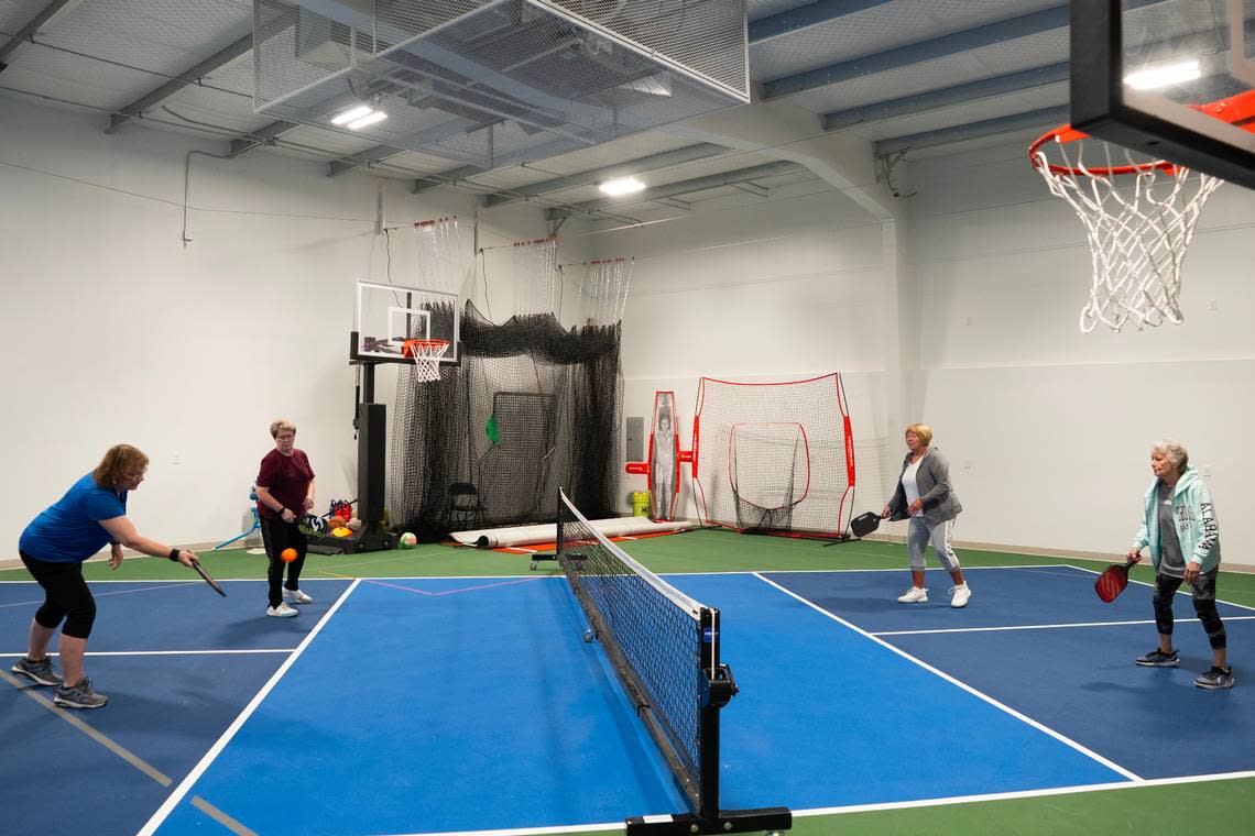 A group of women play pickleball in a unit at the Sandlot Garage Condos at 7454 W. 33rd St. N. The units are sold, not rented, and come in a variety of sizes that owners customize to fit their needs.