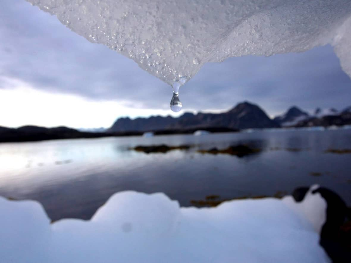 In this Aug. 2005 file photo, an iceberg melts in Kulusuk, Greenland, near the Arctic Circle. A new report says the Arctic will be dominated by rain, rather than snow, sometime between 2050 and 2080.  (John McConnico/The Associated Press - image credit)