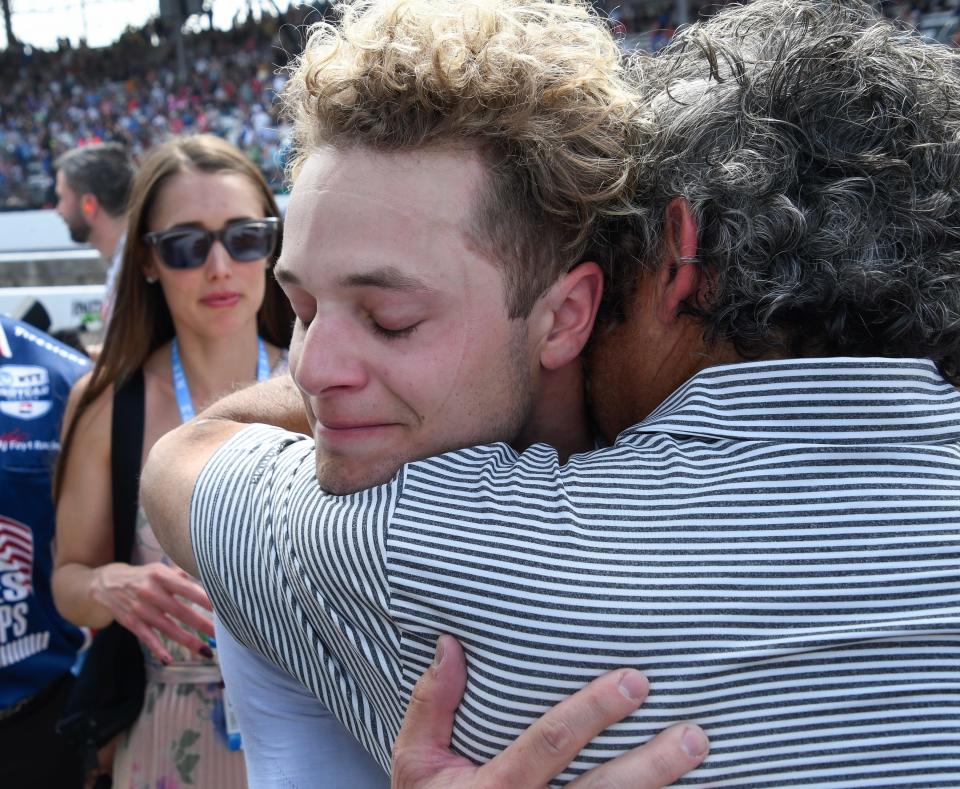 An emotional A. J. Foyt Enterprises driver Santino Ferrucci (14) hugs friends and members of his team on Sunday, May 28, 2023, immediately after the 107th running of the Indianapolis 500 at Indianapolis Motor Speedway, where he finished third.