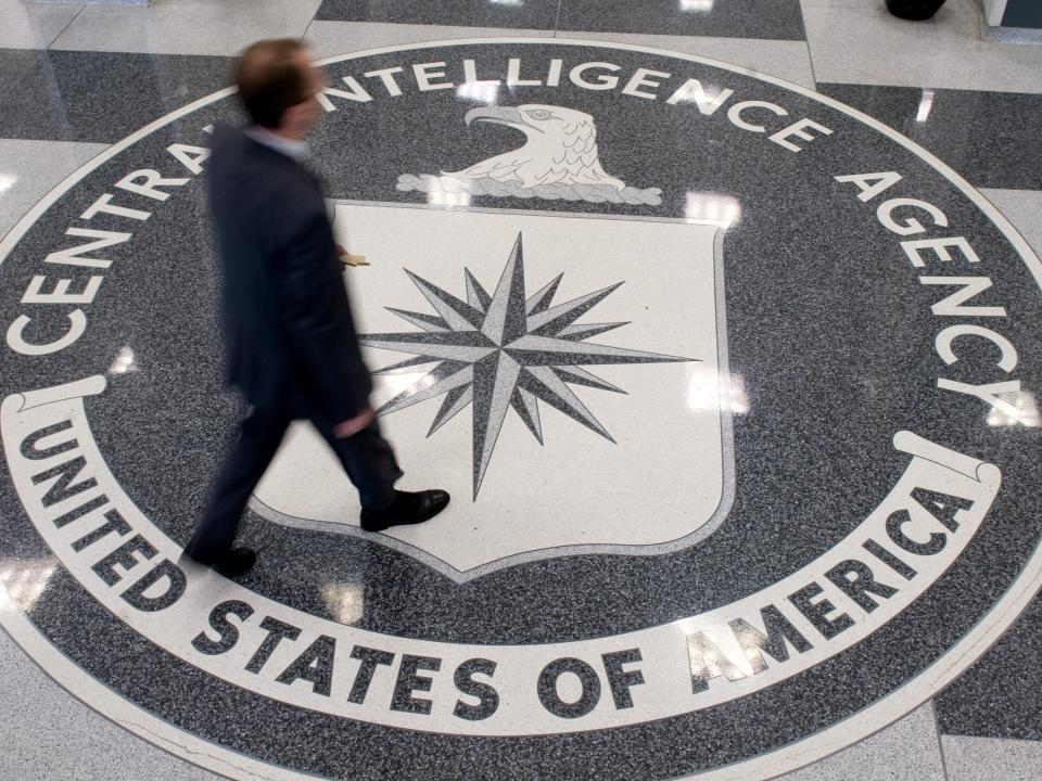 A man crosses the Central Intelligence Agency (CIA) logo in the lobby of CIA Headquarters in Langley, Virginia, on 14 August 14 2008 ((AFP via Getty Images))