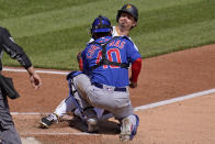 Pittsburgh Pirates' Bryan Reynolds, right, is tagged out by Chicago Cubs catcher Willson Contreras attempting to score on a fielder's choice during the fifth inning of a baseball game in Pittsburgh, Sunday, April 11, 2021. (AP Photo/Gene J. Puskar)