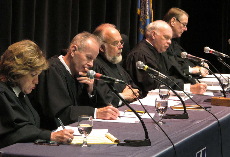 Hon. Kathleen Caldwell (left to right) and members of the South Dakota Supreme Court, John Konenkamp, Chief Justice David Gilbertson, Glen Severson and Steven Zinter listen during a hearing on Wednesday, Oct. 3, 2012 at the Jeschke Fine Arts Center at the University of South Dakota in SIoux Falls, S.D. (AP Photo/Argus Leader, Jay Pickthorn)