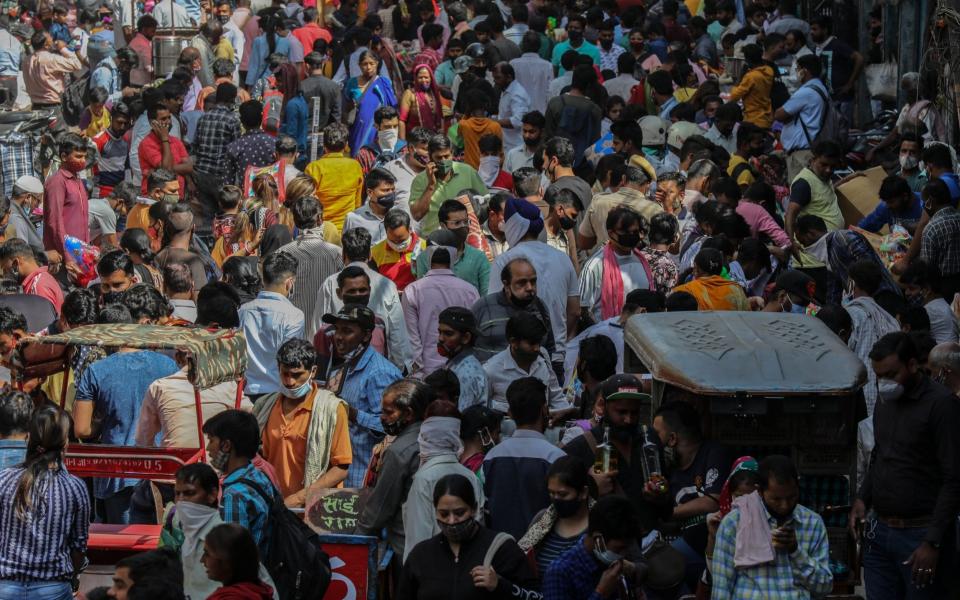 People crowd a wholesale shopping market ahead of Holi festival in New Delhi, India, 26 March 2021 - RAJAT GUPTA/EPA-EFE/Shutterstock