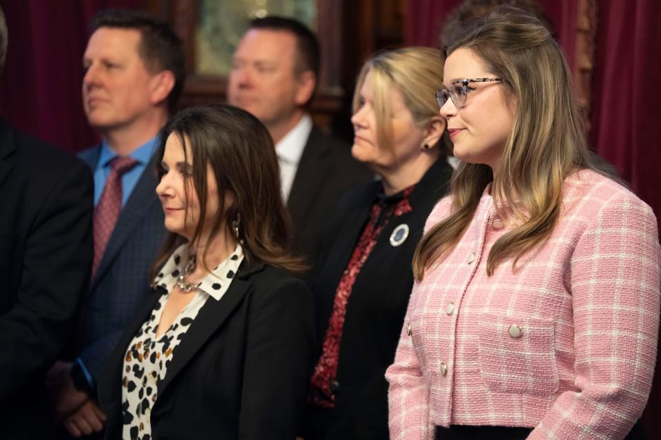 McKenzie Snow, Gov. Kim Reynolds' nominee to lead Iowa's education department, watches as Gov. Reynolds signs House File 2612, Wednesday, March 27, 2024, at her office in the Iowa State Capitol.
