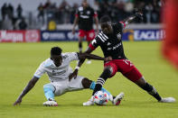 New England Revolution midfielder Luis Caicedo (27) and D.C. United forward Nigel Robertha (19) battle for the ball during the second half of an MLS soccer match, Wednesday, Oct. 20, 2021, in Washington. The Revolution won 3-2. (AP Photo/Alex Brandon)