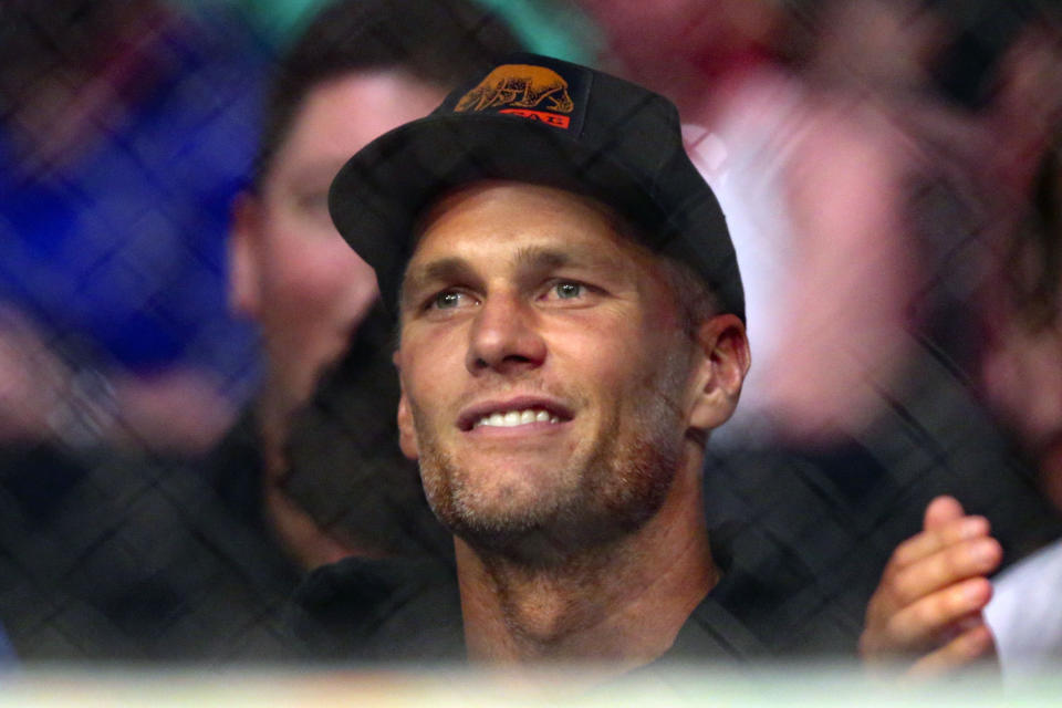 Tampa Bay Buccaneers quarterback Tom Brady watches a UFC 261 mixed martial arts bout, Saturday, April 24, 2021, in Jacksonville, Fla. It is the first UFC event since the onset of the COVID-19 pandemic to feature a full crowd in attendance. (AP Photo/Gary McCullough)