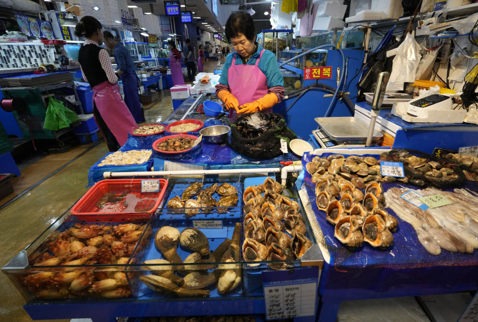 A fish monger works at the Noryangjin Fisheries Wholesale Market in Seoul, South Korea, Friday, July 7, 2023. South Korea's government on Friday formally endorsed the safety of Japanese plans to release treated wastewater from the crippled Fukushima nuclear power plant into sea as it tried to calm people's fears about food contamination. (AP Photo/Ahn Young-joon)