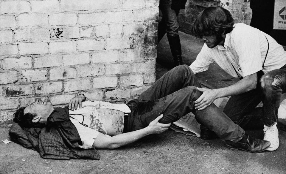 FILE - A youth grimaces with pain from birdshot wounds received when police opened fire on what they described as rock-throwing demonstrators during a riot that followed a rally protesting the fencing in of People's Park in Berkeley, Calif., May 15, 1969. The three-acre site's colorful history, forged from University of California, Berkeley's seizure of the land in 1968, has been thrust back into the spotlight by the school's renewed effort to pave over People's Park as part of a $312 million project that includes sorely needed housing for about 1,000 students. (AP Photo/Sal Veder)