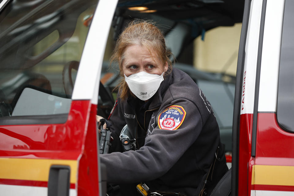 An FDNY medical worker wears personal protective equipment outside a COVID-19 testing site at Elmhurst Hospital Center, Wednesday, March 25, 2020, in New York. Gov. Andrew Cuomo sounded his most dire warning yet about the coronavirus pandemic Tuesday, saying the infection rate in New York is accelerating and the state could be as close as two weeks away from a crisis that sees 40,000 people in intensive care. Such a surge would overwhelm hospitals, which now have just 3,000 intensive care unit beds statewide. (AP Photo/John Minchillo)