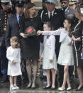 Shannon Slutman holds the fire helmet of her late husband, U.S. Marine Corps Staff Sergeant and FDNY Firefighter Christopher Slutman, while standing with their children as his casket leaves St. Thomas Episcopal Church, Friday April 26, 2019, in New York. (AP Photo/Bebeto Matthews)