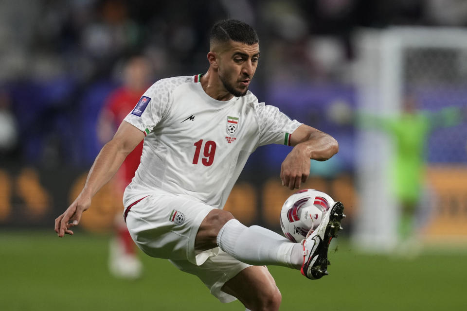 Iran's Majid Hosseini controls the ball during the Asian Cup Group C soccer match between Hong Kong and Iran at Khalifa International Stadium in Doha, Qatar, Friday, Jan. 19, 2024. (AP Photo/Thanassis Stavrakis)