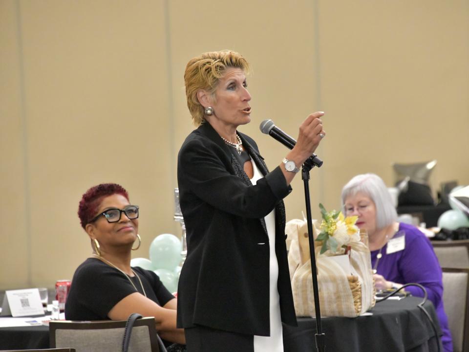 A woman speaking into a microphone