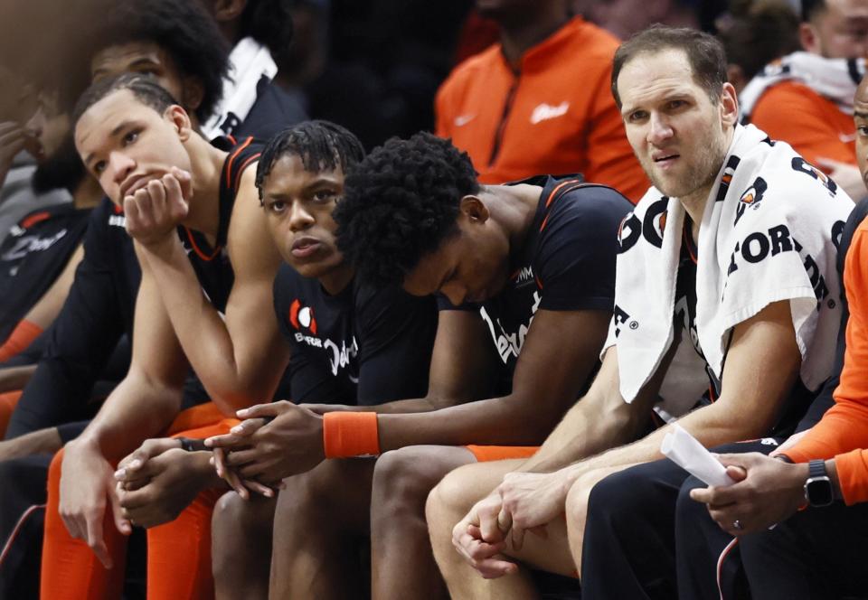 Detroit Pistons forward Kevin Knox II, from left, guard Marcus Sasser, forward Ausar Thompson and forward Bojan Bogdanovic sit on the bench during the fourth quarter of a 118-112 loss to the Brooklyn Nets, an NBA record 27th straight loss, Tuesday, Dec. 26, 2023, in Detroit. (AP Photo/Duane Burleson)