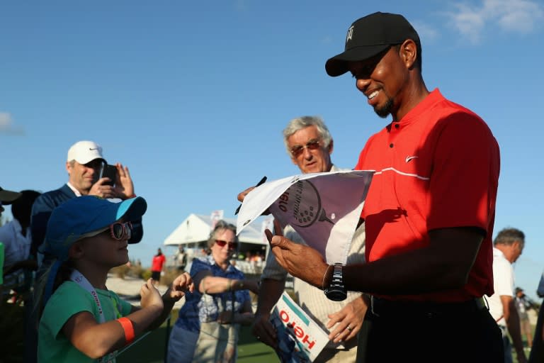 Tiger Woods of the United States signs autographs for young fans following the final round of the Hero World Challenge at Albany, The Bahamas on December 4, 2016