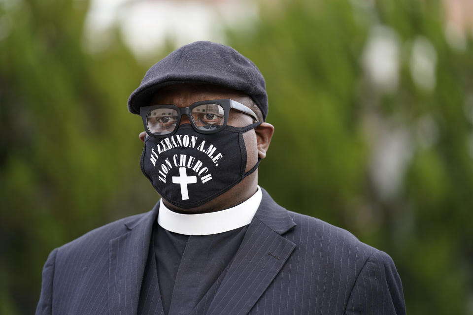 Pastor Javan Leach, of Mt. Lebanon AME Zion Church watches as people gather for a peaceful demonstration, Thursday, April 22, 2021, in Elizabeth City, N.C., protesting the shooting of Andrew Brown Jr., 42, by a deputy sheriff trying to serve a search warrant. (AP Photo/Gerry Broome)