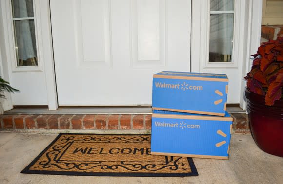 Two Wal-Mart boxes stacked in front of a door.