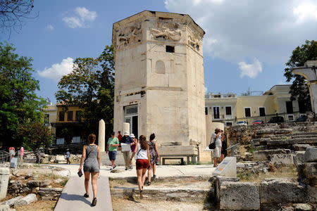 Tourists visit the Tower of the Winds, open to the public for the first time in more than 200 years after being restored, in the Roman Agora, in Plaka, central Athens, Greece, August 23, 2016. Picture taken August 23, 2016. REUTERS/Michalis Karagiannis