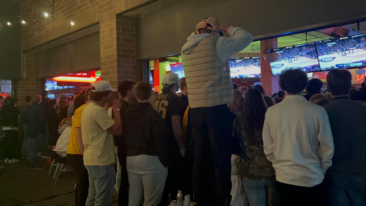 Fans at Brother Bar & Grill in downtown Iowa City watch the Iowa vs. UConn game intensely during the final minutes.