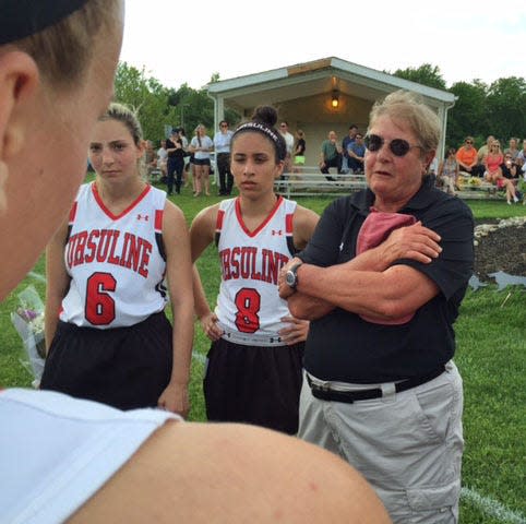 Ursuline lacrosse coach Feffie Barnhill talks to her team after a 2015 game.