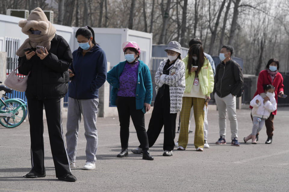 Residents line up for a COVID-19 test at a mobile testing site on Tuesday, March 15, 2022, in Beijing. China's new COVID-19 cases Tuesday more than doubled from the previous day as the country faces by far its biggest outbreak since the early days of the pandemic. (AP Photo/Ng Han Guan)