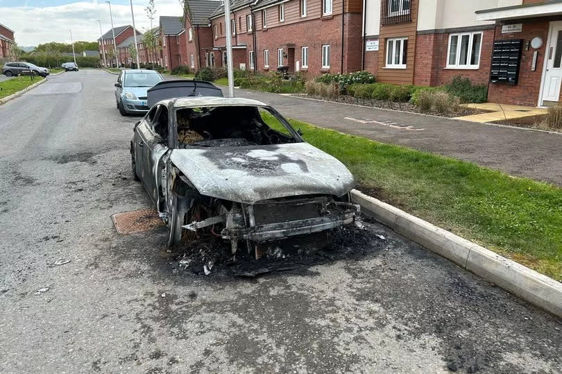 The destroyed car on a street in Cranbrook