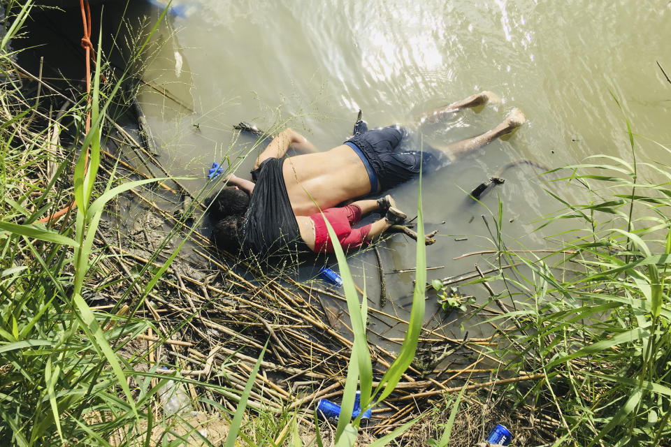 EDS NOTE: GRAPHIC CONTENT - The bodies of Salvadoran migrant Oscar Alberto Martínez Ramírez and his nearly 2-year-old daughter Valeria lie on the bank of the Rio Grande in Matamoros, Mexico, Monday, June 24, 2019, after they drowned trying to cross the river to Brownsville, Texas. Martinez' wife, Tania told Mexican authorities she watched her husband and child disappear in the strong current. (AP Photo/Julia Le Duc)