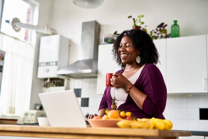 woman drinking coffee in her kitchen