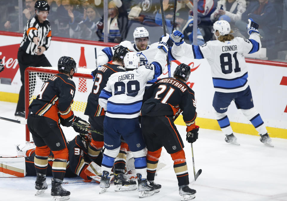 Winnipeg Jets' Pierre-Luc Dubois (80), Sam Gagner (89) and Kyle Connor (81) celebrate after Connor's goal against Anaheim Ducks goaltender John Gibson (36) during second-period NHL hockey game action in Winnipeg, Manitoba, Thursday, Nov. 17, 2022. (John Woods/The Canadian Press via AP)